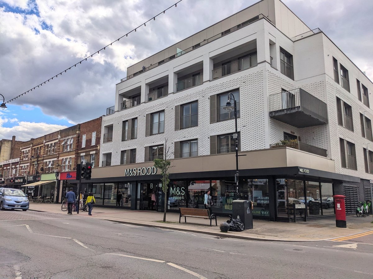 Modern apartment block with a ground-floor storefront